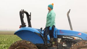 man standing on tractor