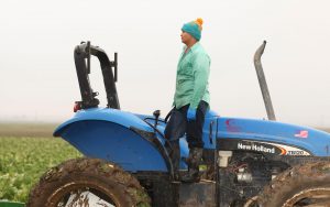 man standing on tractor