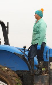 man standing on tractor